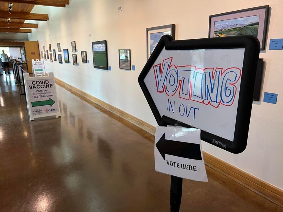 Signs in a hallway of the New Mexico Farm and Ranch Heritage Museum in Las Cruces direct visitors to a voting location as well as a free COVID-19 vaccination clinic on Tuesday, Nov. 2, 2021.