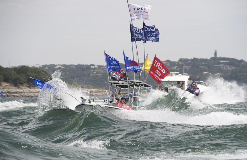 FILE - In this Saturday, Sept. 5, 2020 file photo, boaters flying flags honoring U.S. President Donald Trump crowd Lake Travis in Lakeway, Texas, during a boat parade that attracted hundreds of watercraft of all sizes. On Friday, Sept. 11, 2020, The Associated Press reported on a photo circulating online incorrectly asserting it shows a white boat that sank to the bottom of Lake Travis in Texas during a boat parade for the president. Several boats sank during the Sept. 5 event, but the photo social media users are sharing was taken in June after a motorboat sank in northern Michigan’s Grand Traverse Bay. (Bob Daemmrich via AP)