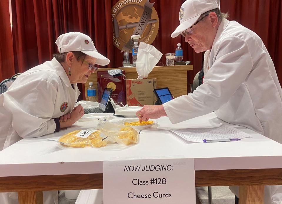 World Championship Cheese Contest judges Kerry Kaylegian and Marianne Smukowski visually inspect cheese curds before tasting and testing for a squeak during the 2022 contest in Madison. It was the first time cheese curds were judged in their own category in the contest run by the Wisconsin Cheese Makers Association.