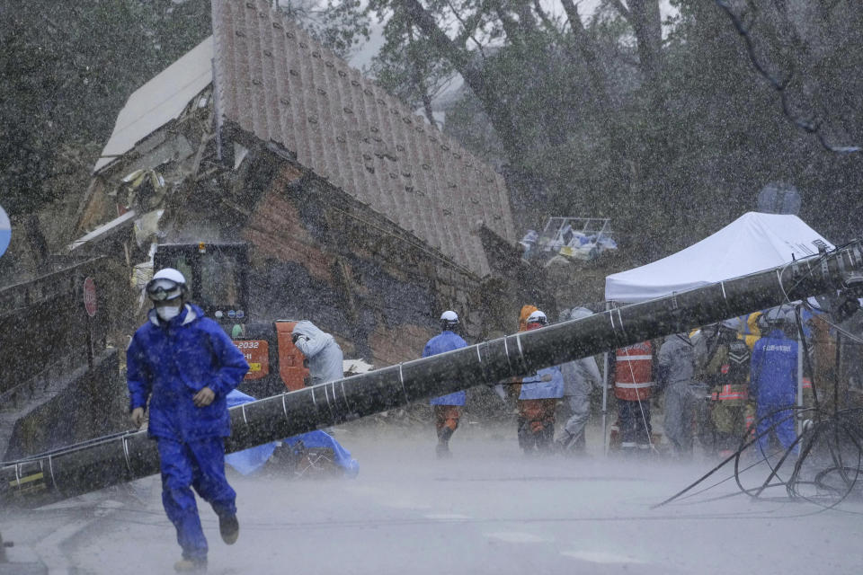 Rescuers halt a search operation due to a strong rain at the site of a landslide in Anamizu town, Ishikawa prefecture, Japan Saturday, Jan. 6, 2024. Monday’s temblor decimated houses, twisted and scarred roads and scattered boats like toys in the waters, and prompted tsunami warnings. (Kyodo News via AP)