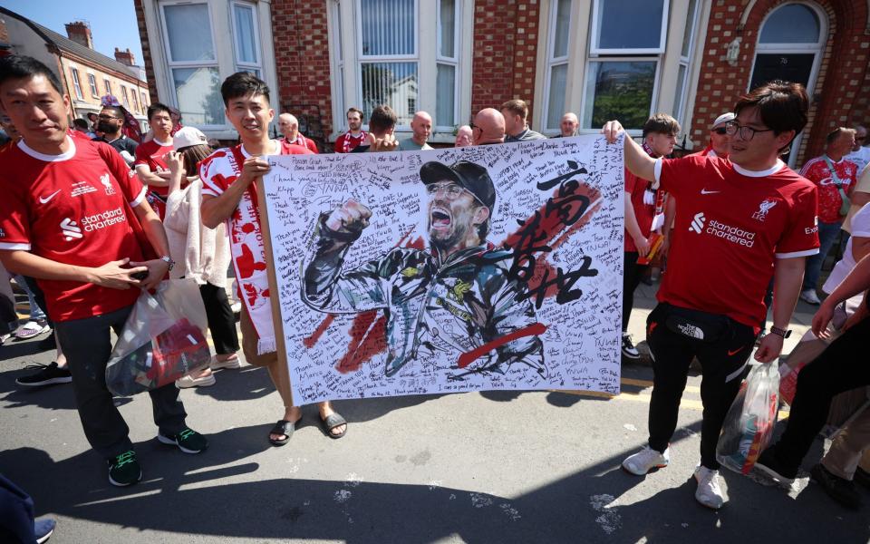 Fans display a drawing in support of Liverpool manager Jurgen Klopp on his last match outside the stadium before the match