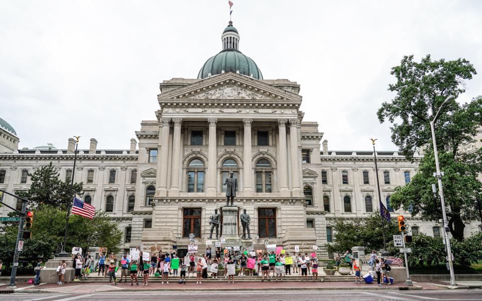 Abortion-rights supporters protest in front of the Indiana Statehouse on Wednesday, July 6, 2022, in Indianapolis. 