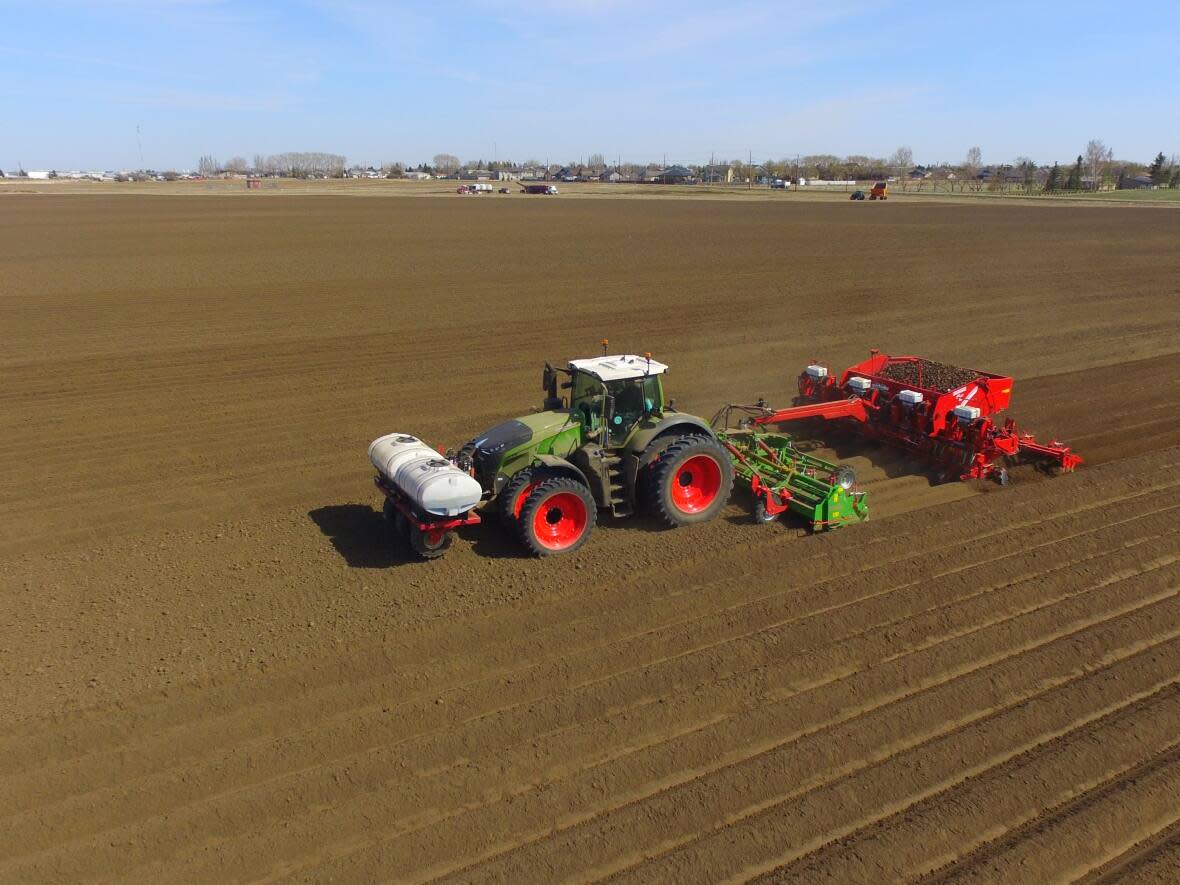A tractor works to plant potatoes at CP Farms Ltd. in southern Alberta in 2018. (Potato Growers of Alberta - image credit)