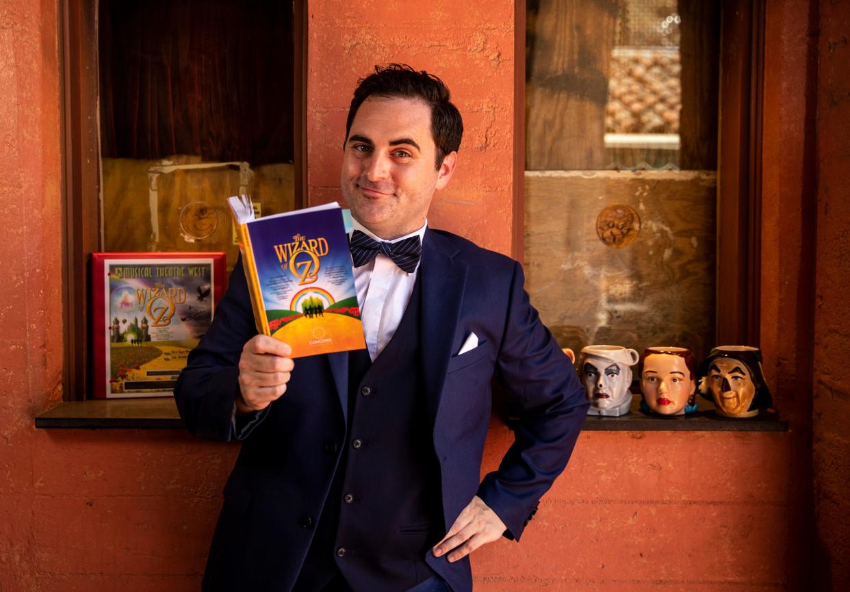 Actor Erik Scott Romney poses for a photo with his copy of the script for The Wizard of Oz at the The Plaza Theatre in Palm Springs, Calif., Saturday, June 17, 2023. 