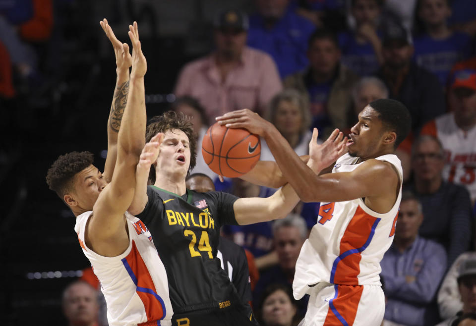 Florida forward Kerry Blackshear Jr. (24) steals the ball from Baylor guard Matthew Mayer (24) as he is defended by Florida forward Keyontae Johnson (11) during the first half of an NCAA college basketball game Saturday, Jan. 25, 2020, in Gainesville, Fla. (AP Photo/Matt Stamey)