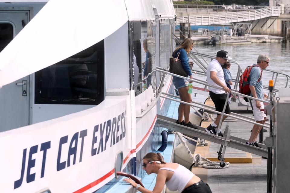 Evacuees from Catalina Island disembark from a ferry.