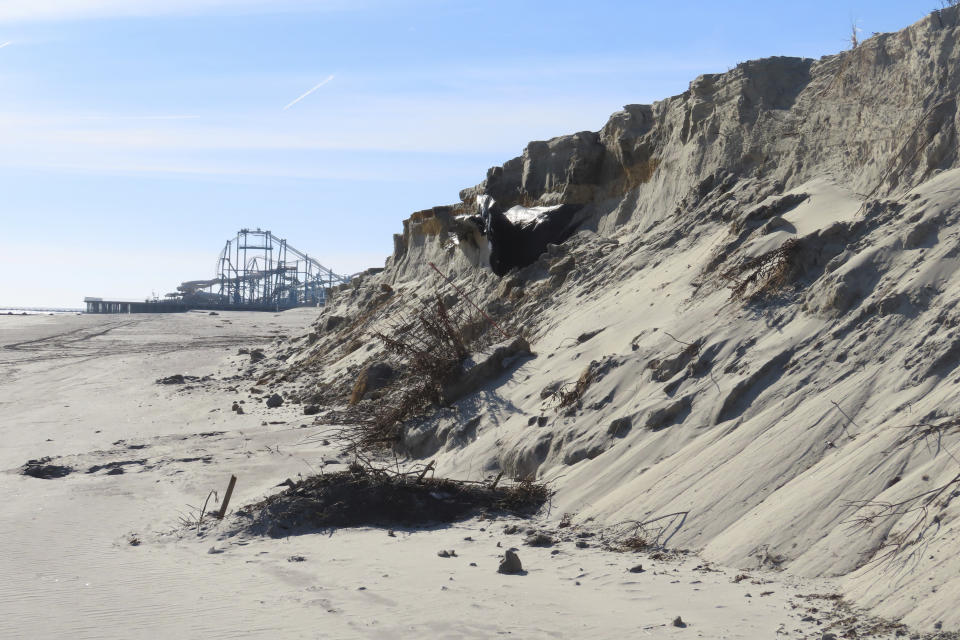 A severely eroded section of sand dune lines the beach in North Wildwood N.J., Jan. 22, 2024. A recent winter storm punched a hole through what is left of the city's eroded dune system, leaving it more vulnerable than ever to destructive flooding as the city and state fight in court over how best to protect the popular beach resort. (AP Photo/Wayne Parry)