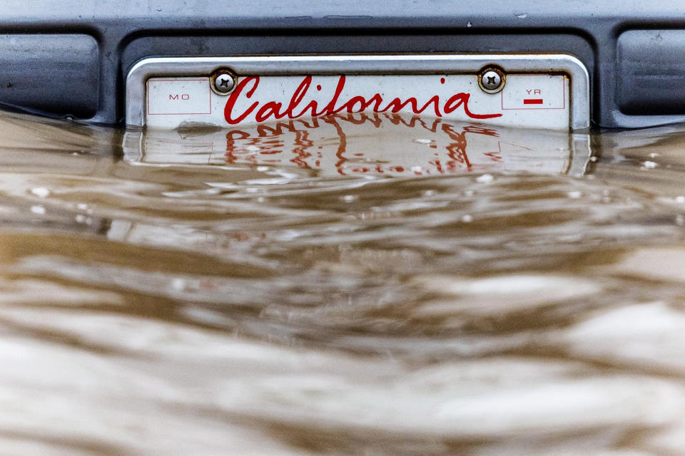 A California license plate is seen after days of heavy rain in Pajaro, California, on March 14, 2023.  