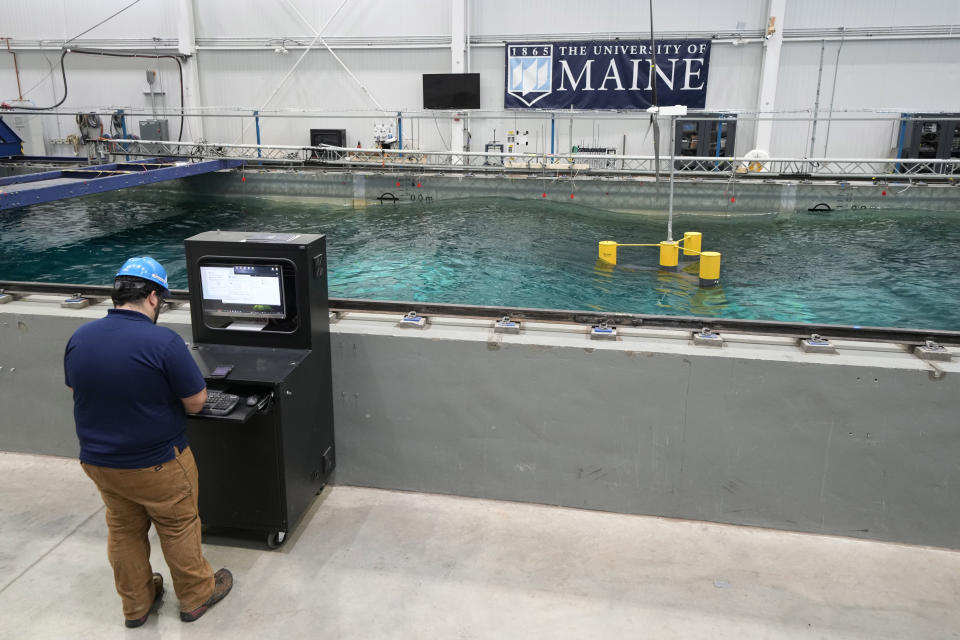 A 13-foot-tall wind turbine is tested for stability in a wave pool, Wednesday, March 27, 2024, at the University of Maine, in Orono, Maine. The waves simulate worst possible conditions for an offshore wind turbine on a 1:70 scale. (AP Photo/Robert F. Bukaty)
