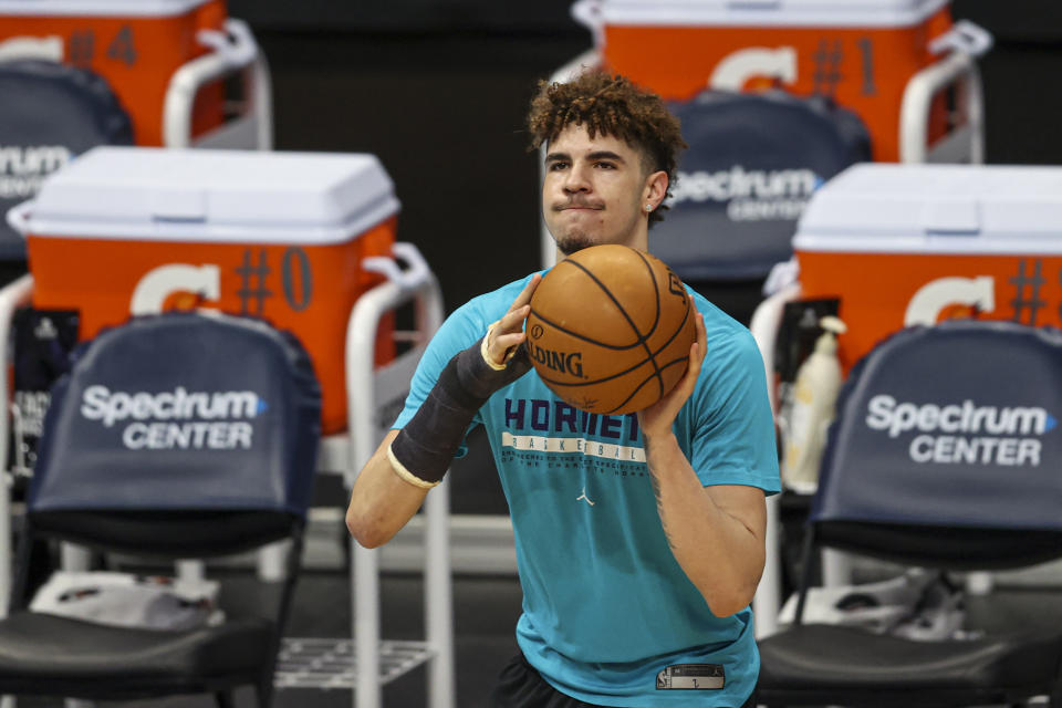 Charlotte Hornets guard LaMelo Ball, wearing a cast on his fractured right wrist, shoots before an NBA basketball game between the Charlotte Hornets and the Atlanta Hawks in Charlotte, N.C., Sunday, April 11, 2021. (AP Photo/Nell Redmond)