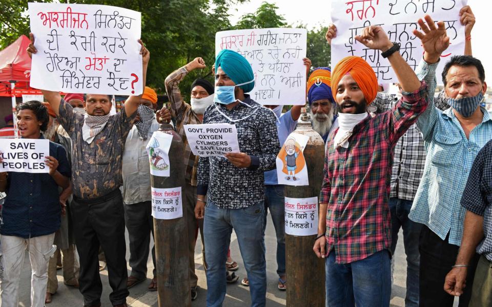 Demonstrator protest over the shortage of oxygen cylinders in Amritsar, India - Narinder Nanu/AFP