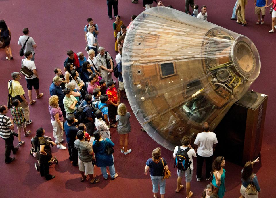 Visitors gather around the Apollo 11 command module “Columbia” that carried astronauts Neil Armstrong, Buzz Aldrin, and Michael Collins on their historic voyage to the Moon and back on July 16 to 24, 1969, at the Smithsonian Institution’s National Air and Space Museum in Washington Saturday, Aug. 25, 2012.
