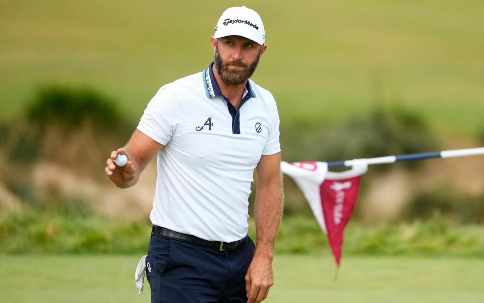 Dustin Johnson waves after his putt on the sixth hole during the first round of the U.S. Open golf tournament at Los Angeles Country Club - Lindsey Wasson/AP