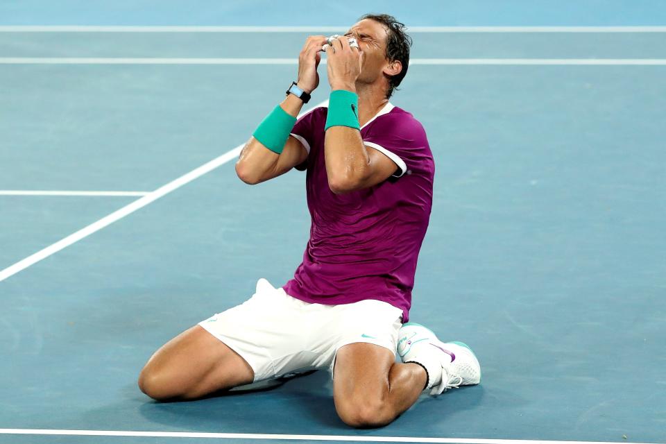 Rafael Nadal (pictured) falls to the ground and celebrates winning the Australian Open.