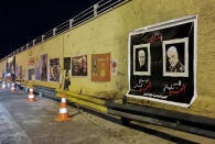 FILE - This Thursday, Jan. 16, 2020 file photo, posters of Iranian General Qassem Soleimani and deputy commander of Iran-backed militias Abu Mahdi al-Muhandis, both killed in a U.S. strike earlier this month, hang on the walls at the site where they were killed in Baghdad, Iraq. The Islamic State group seemed largely defeated last year, with the loss of its territory, the killing of its founder in a U.S. raid and an unprecedented crackdown on its social media propaganda machine but tensions between the U.S. and Iran in the region provide a comeback opportunity for the extremist group. (AP Photo/Hadi Mizban, File)