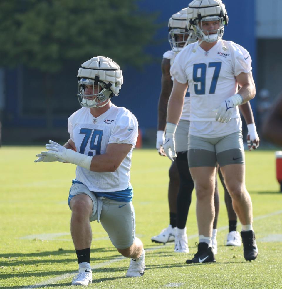 Lions defensive linemen John Cominsky stretches during practice Thursday, July 28, 2022 at the Allen Park practice facility.