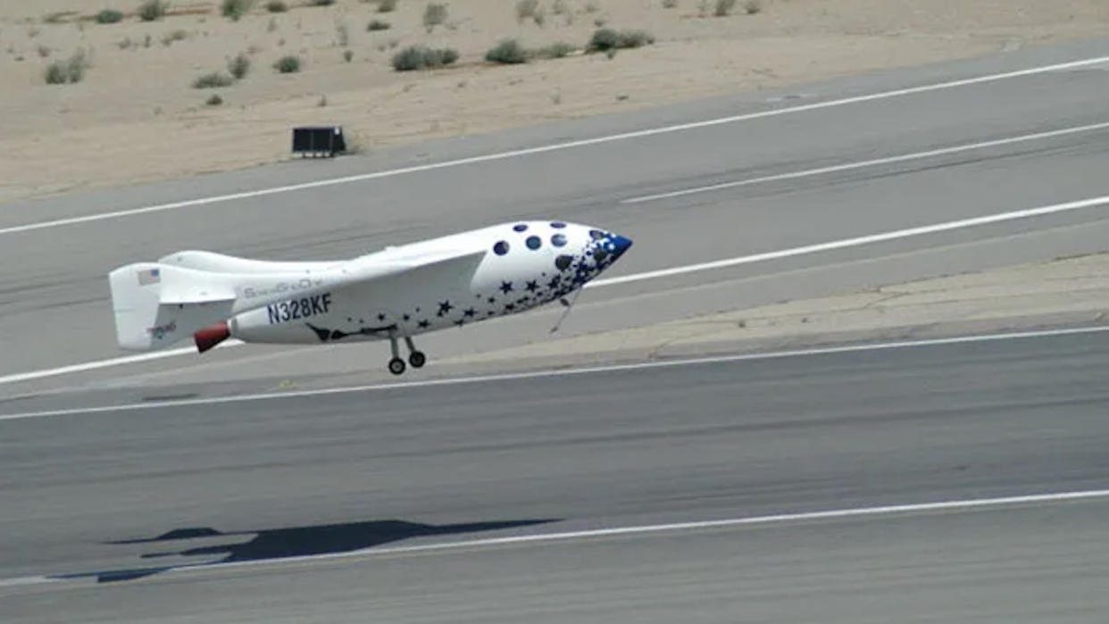  A small white space plane comes down for a landing at a runway in the desert. 