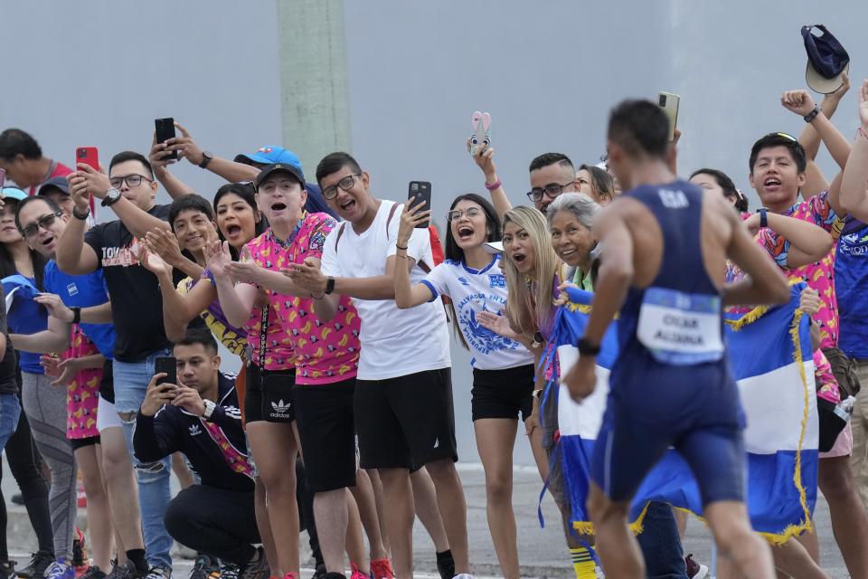 FILE - Fans cheer on El Salvador's Oscar Aldana in the men's athletics half marathon final during the Central American and Caribbean Games, in San Salvador, El Salvador, July 2, 2023. The games have offered the government of Nayib Bukele an opportunity to showcase a safer El Salvador in the largest international event here, where crime has dipped to historic lows, and Bukele's approval has soared, holding strong at 90% in June, according to a CID Gallup poll. (AP Photo/Arnulfo Franco, File)