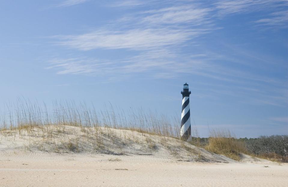 <p>Nestled in North Carolina's Outer Banks, the striped Hatteras Lighthouse has been standing above the dunes since 1870. </p>