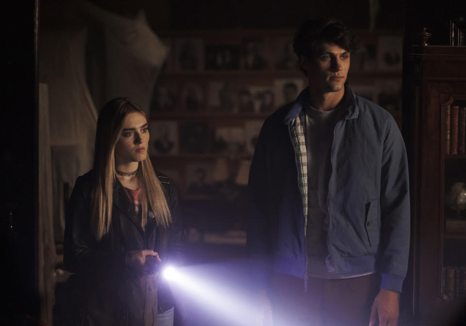 This image released by The CW shows Meg Donnelly, left, and Drake Rodger in a scene from "The Winchesters," a prequel to the long-running series "Supernatural." (Matt Miller/The CW via AP)