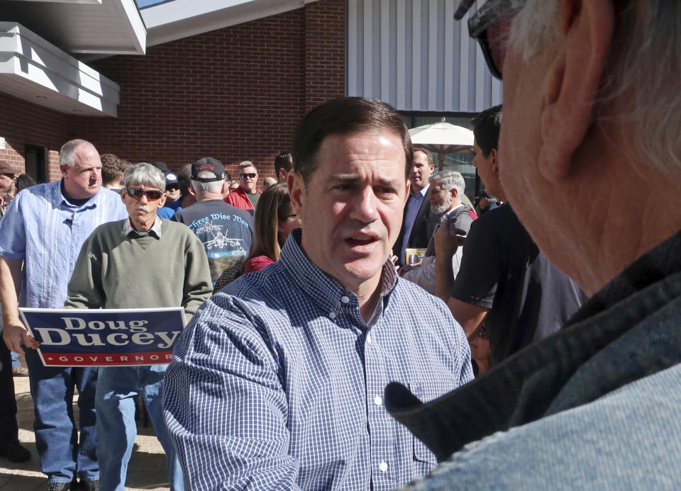 Arizona Gov. Doug Ducey talks with the crowd at a Republican rally on Monday, Nov. 5, 2018 in Flagstaff, Arizona. (AP Photo/Felicia Fonseca)