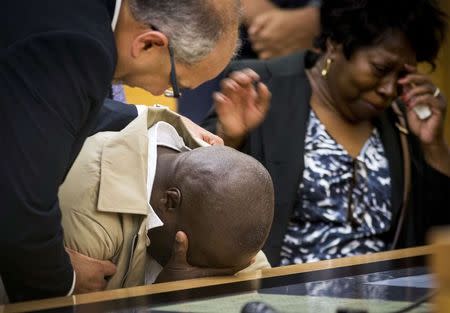 David McCallum (C) reacts after hearing his conviction was overturned at Brooklyn Supreme Court in the Brooklyn Borough of New York October 15, 2014. REUTERS/Brendan McDermid