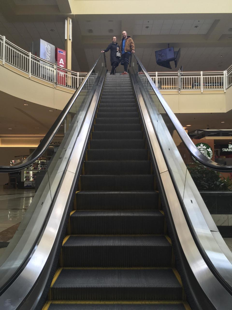 Courtney Taylor and her boyfriend, Zach Tobias, ride the escalator at a mall in Whitehall, Pa., on Feb. 9, 2017. Taylor and Tobias don’t mix shopping with politics, but say it seems to be happening more often during the Donald Trump era as activists who either oppose or support the president target stores and brands for boycotts. (AP Photo/Michael Rubinkam)