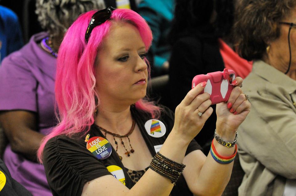 Mia Raven of Alabama Reproductive Rights Advocates uses her phone to take images during a public hearing on H.B. 56, "The Freedom of Religion in Marriage Protection Act", held in 2015 before the Health and Human Services sub-committee at the Alabama State House in Montgomery.