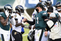 Philadelphia Eagles' Carson Wentz, right, and Baltimore Ravens' Lamar Jackson meet after an NFL football game, Sunday, Oct. 18, 2020, in Philadelphia. (AP Photo/Derik Hamilton)