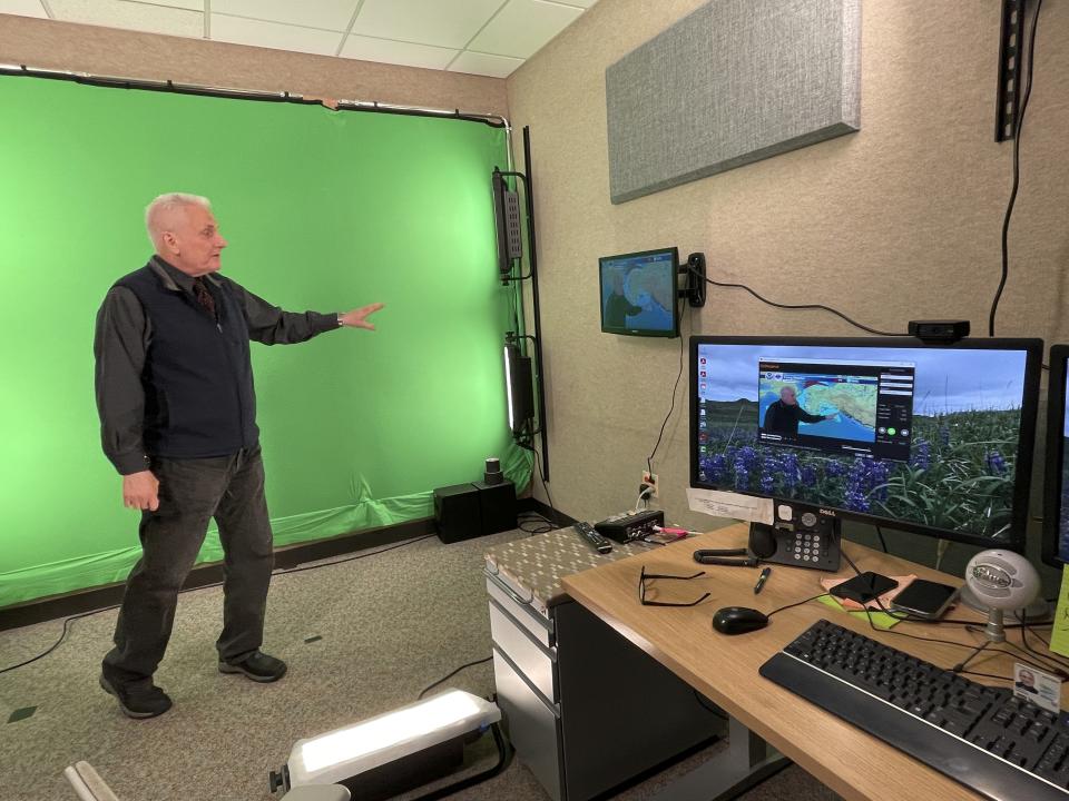 In this June 21, 2023, photo, meteorologist David Percy films the daily "Alaska Weather" program in a makeshift studio at the National Weather Service office in Anchorage, Alaska. The "Alaska Weather" program she oversees, the only weather show produced by the National Weather Service, will have its last on-air broadcast Friday after Alaska Public Media dropped distribution, forcing it to YouTube. (AP Photo/Mark Thiessen)