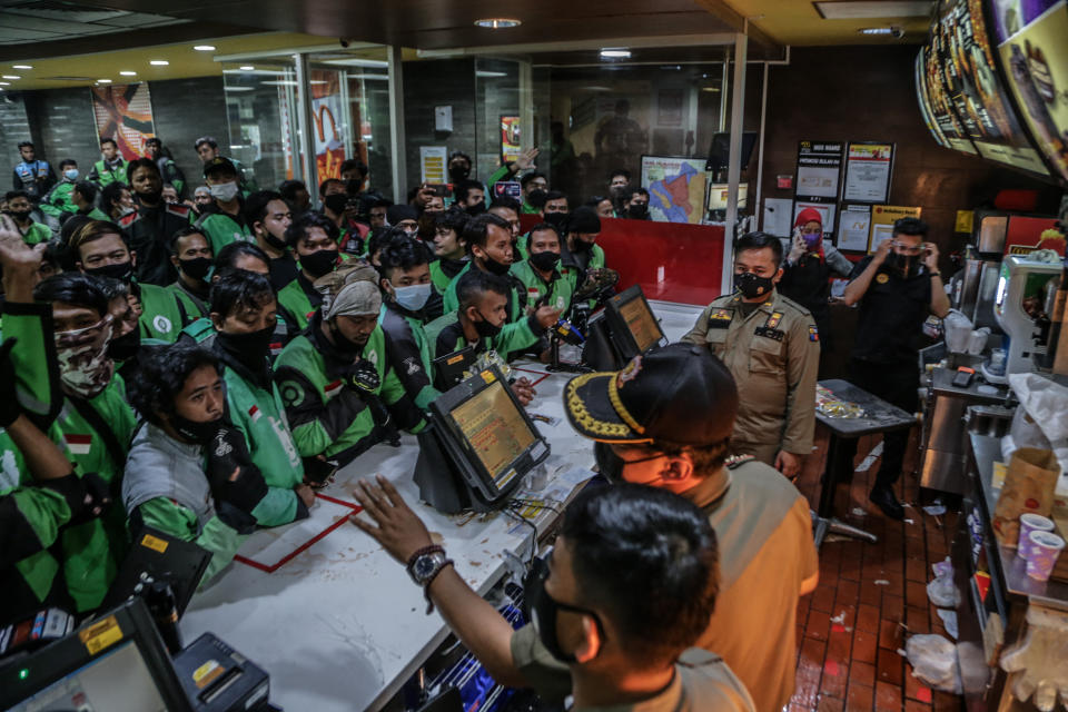 Food delivery riders queue up at a McDonalds outlet in Bogor on June 9, to buy the new BTS-meal deal for hungry fans in the K-Pop mad country. Source: AFP via Getty Images 