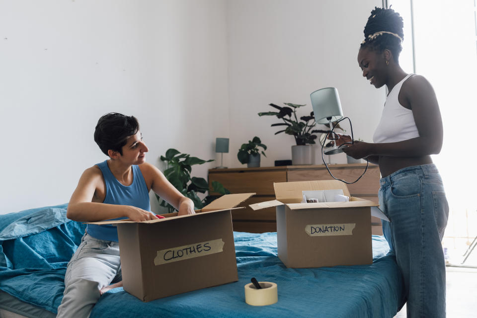 Couple decluttering house deciding which items to keep and which to donate