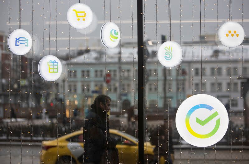 FILE PHOTO: A man walks past an office of the Russian largest lender Sberbank in Moscow