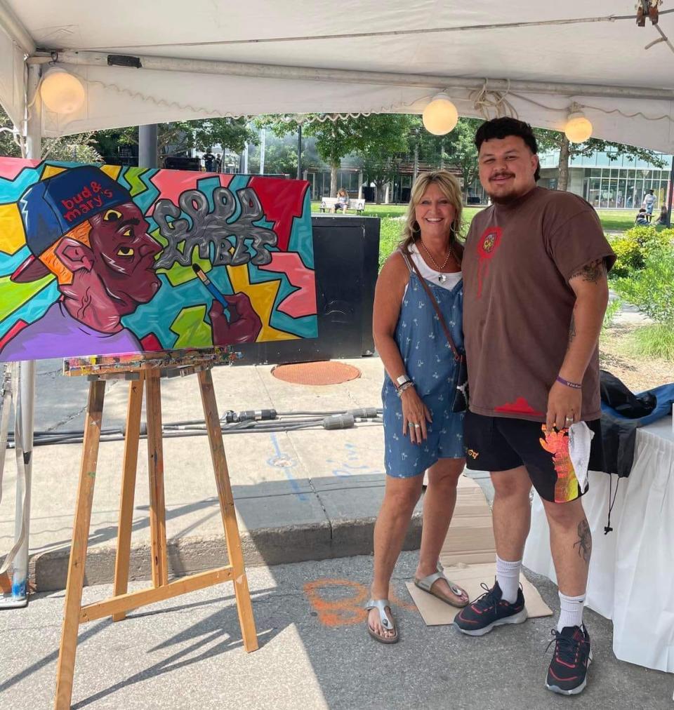 Shelli Hassebrock, a former Ames High School art teacher, poses for a photo with her former student, Siriaco "Siricasso" Garcia.