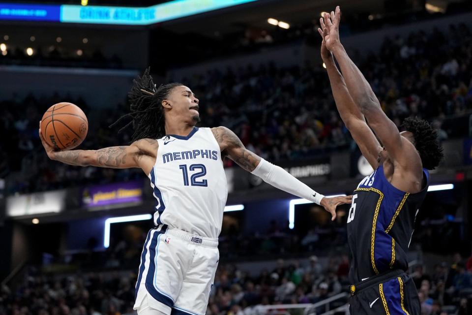 Ja Morant dunks the ball over Jalen Smith of the Indiana Pacers in the third quarter at Gainbridge Fieldhouse on January 14, 2023, in Indianapolis, Indiana.