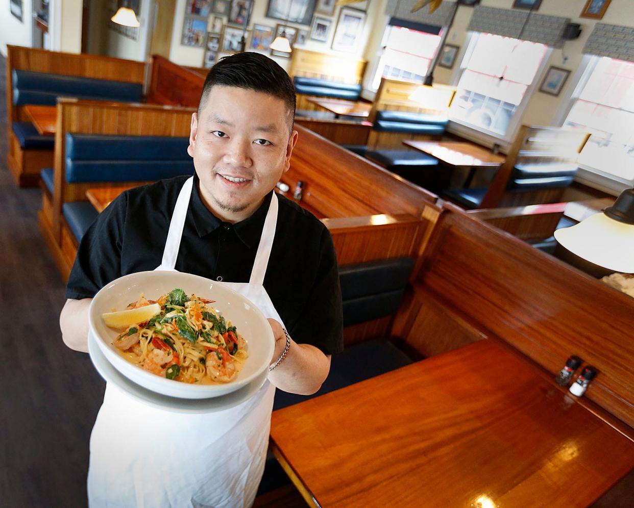 Chef David Dang shows off his lemon garlic shrimp and pasta dish at Jake's Seafood Restaurant and Fish Market on Hull Harbor