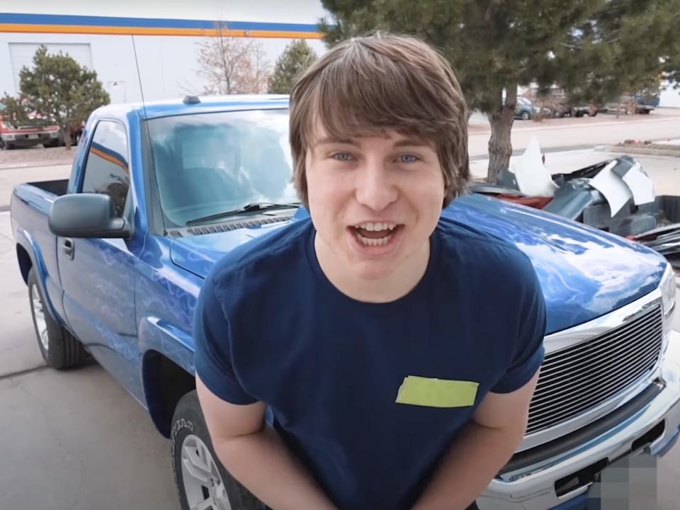 A picture of Matthew Beem in front of a custom car.