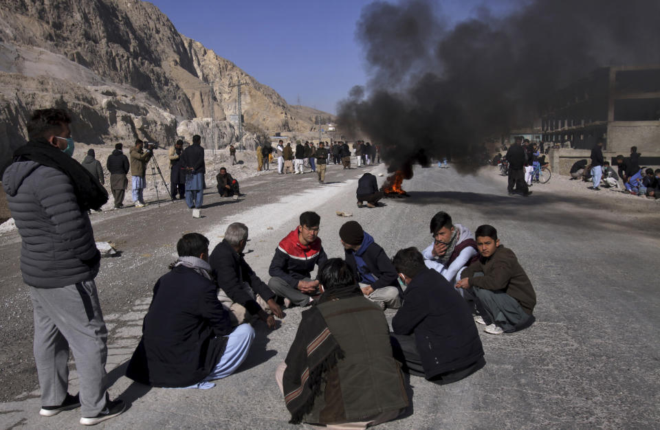 FILE - In this Jan. 3, 2021, file photo, people from the Shiite Hazara community burn tires and block a road in protest of the killing of coal mine workers by unknown gunmen near the Machh coal field, in Quetta, Pakistan. Militant attacks are on the rise in Pakistan amid a growing religiosity that has brought greater intolerance, prompting one expert to voice concern the country could be overwhelmed by religious extremism. (AP Photo/Arshad Butt, File)