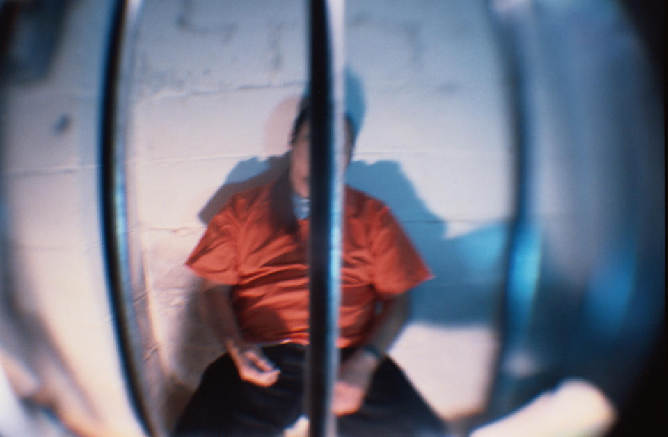 A man sitting in a jail cell