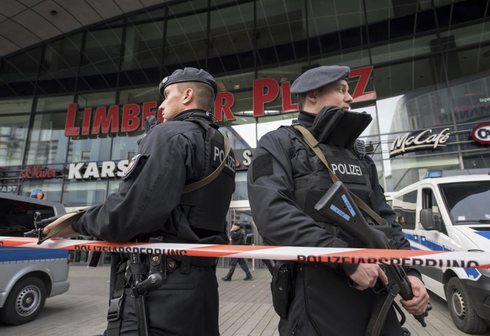 Police guard in front of a shopping mall in Essen, Germany, Saturday, March 11, 2017. Police have ordered the shopping mall in the western German city of Essen not to open after receiving credible tips of an imminent attack. The shopping center and the adjacent parking lot stayed closed Saturday morning as over a hundred police officers searched the compound. (Bernd Thissen/dpa via AP)