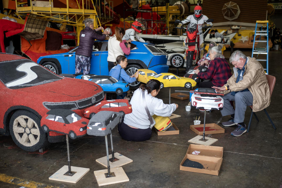 People work on Honda's "Keep Dreaming" Rose Parade float