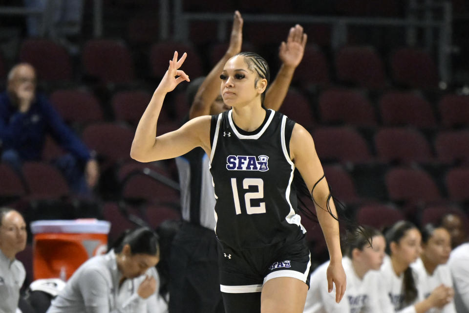 Stephen F. Austin guard Kyla Deck (12) reacts after a 3-point basket against the California Baptist during the first half of an NCAA college basketball game in the championship of the Western Athletic Conference women's tournament, Saturday, March 16, 2024, in Las Vegas. (AP Photo/David Becker)