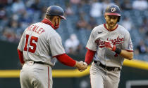 Washington Nationals' Trea Turner, right, is congratulated by third base coach Bob Henley after hitting a home run against the Arizona Diamondbacks during the first inning of a baseball game Friday, May 14, 2021, in Phoenix. (AP Photo/Darryl Webb)