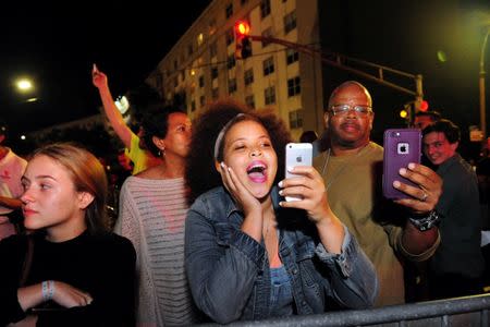 Sidney Bechet Blanchard and her father, jazz trumpeter Terence Blanchard, live stream as construction crew works to remove a monument of Confederate General P.G.T. Beauregard at the entrance to City Park in New Orleans, Louisiana, U.S. May 16, 2017. REUTERS/Cheryl Gerber