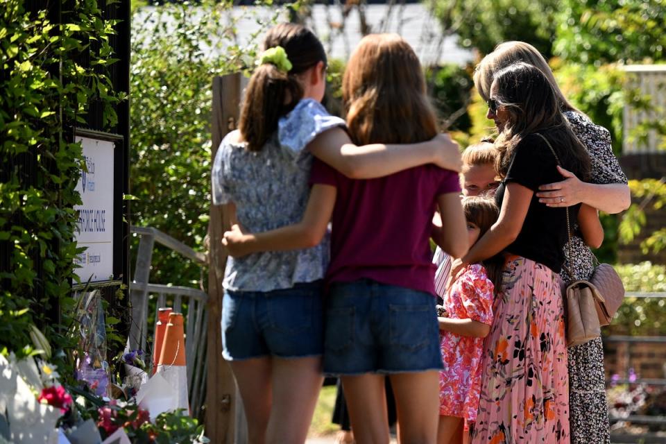 Children consoled each other as they read tributes to their friend on Friday (Getty Images)