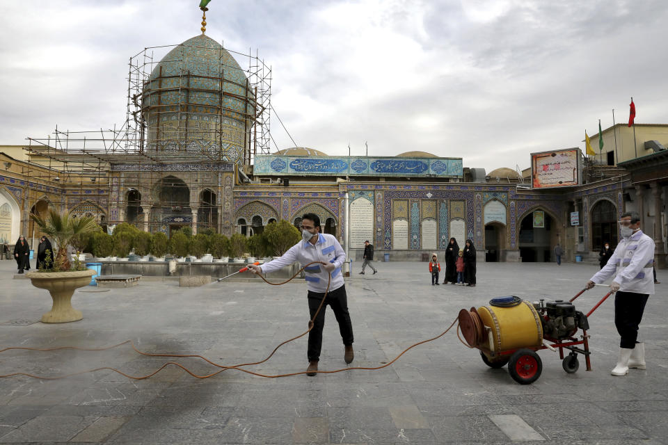 Workers disinfect the shrine of the Shiite Saint Imam Abdulazim to help prevent the spread of the new coronavirus in Shahr-e-Ray, south of Tehran, Iran, Saturday, March, 7, 2020. (AP Photo/Ebrahim Noroozi)