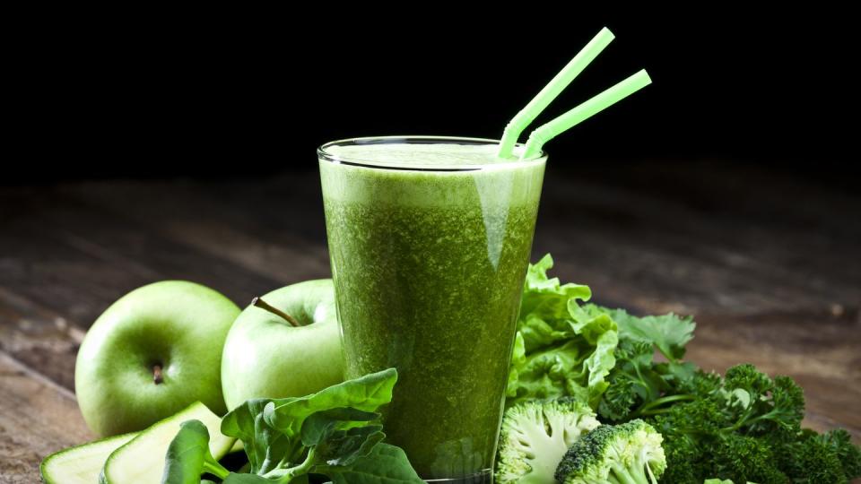 green vegetable juice on rustic wood table