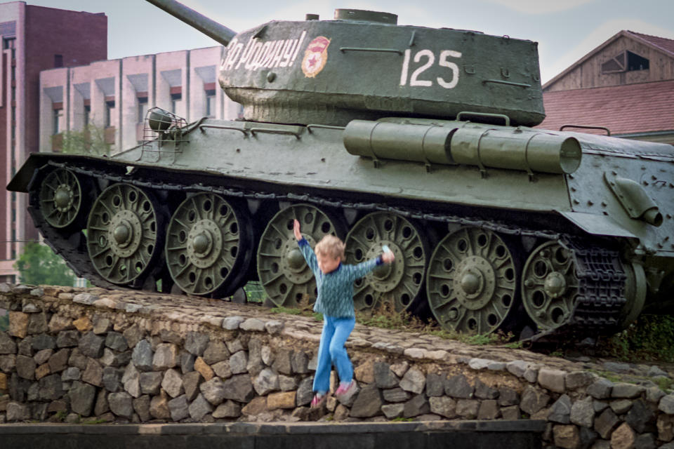 FILE - A child plays near a Red Army tank at a WWII memorial in Tiraspol, the capital of the Russia-backed breakaway region of Transnistria, in Moldova, in 1991. Since Russia fully invaded Ukraine two years ago, a string of incidents in neighboring Moldova's Russia-backed breakaway region of Transnistria have periodically raised the specter that European Union candidate Moldova could also be in Moscow's crosshairs. (AP Photo/Vadim Ghirda, File)