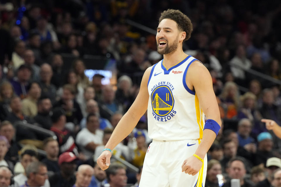 Golden State Warriors guard Klay Thompson reacts after scoring against the Phoenix Suns during the first half of an NBA basketball game, Tuesday, Dec. 12, 2023, in Phoenix. (AP Photo/Rick Scuteri)