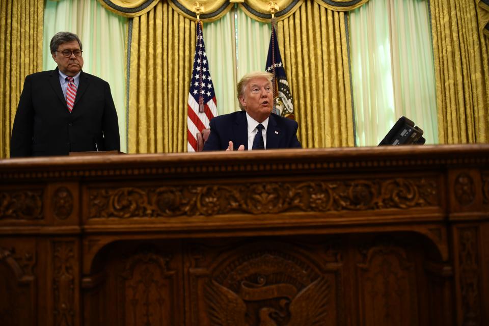 US President Donald Trump speaks as US Attorney General William Barr listens before signing an executive order on social-media companies in the Oval Office of the White House on May, 28, 2020. (Photo by Brendan Smialowski / AFP) (Photo by BRENDAN SMIALOWSKI/AFP via Getty Images)